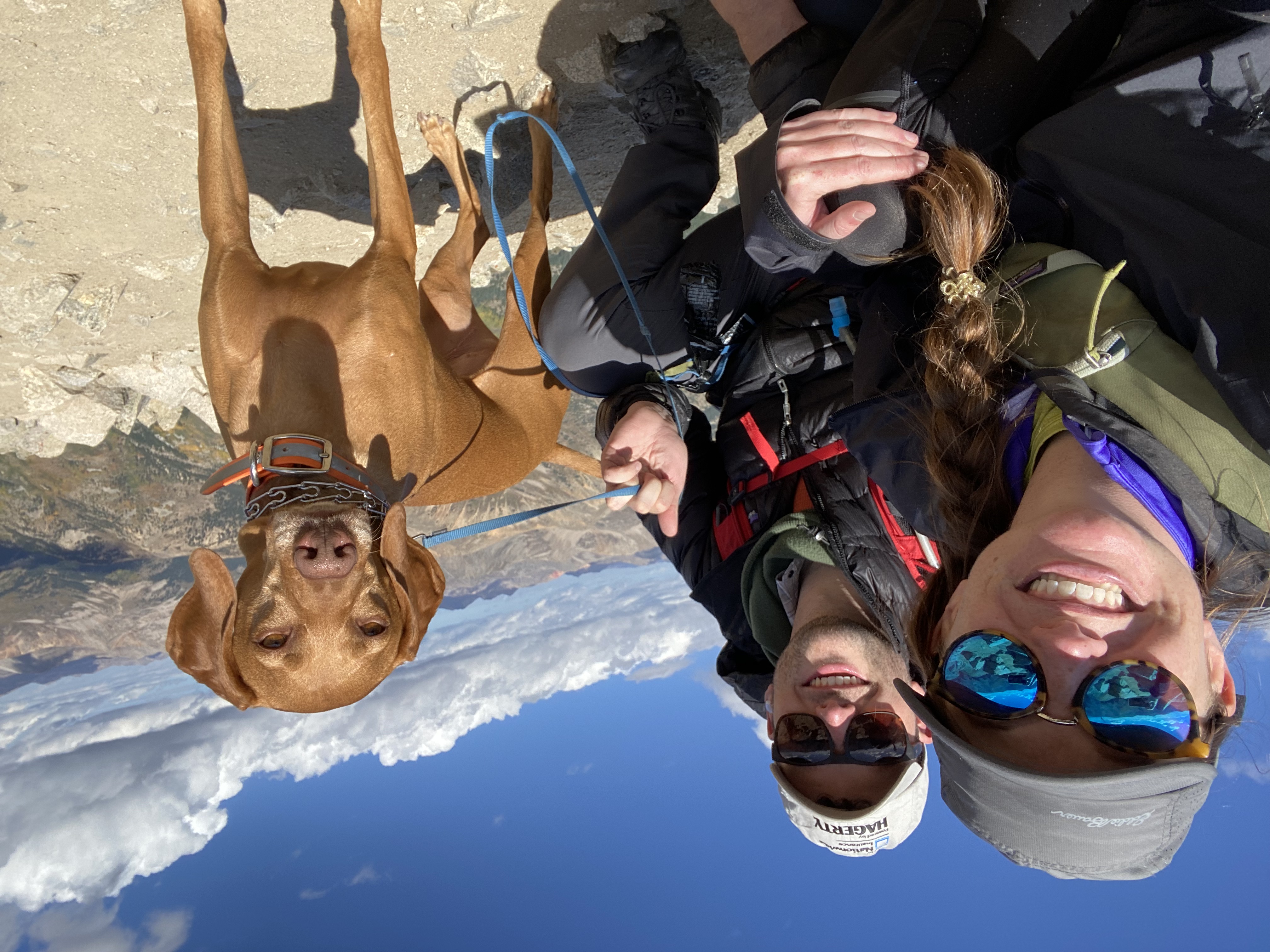 On top of a mountain with fiance and dog